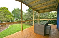 The large rear deck overlooks the backyard and is fully fenced in, making it safe for children and pets.  It has a roof, making it an ideal spot to read a book or enjoy a cold drink in all weather conditions.